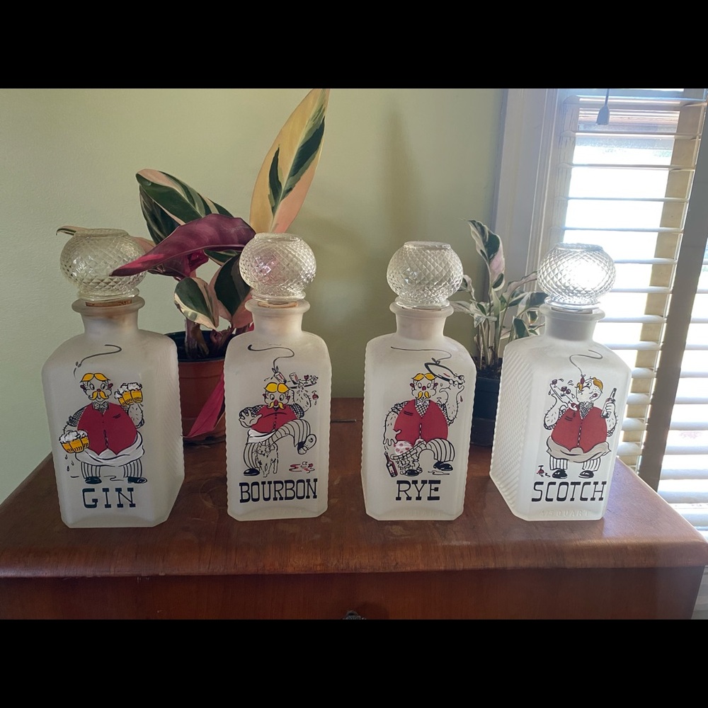Set of 4 Vintage hand painted glass decanters.